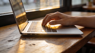 Apple MacBook Air M2 silver model on a cafe table for remote work.