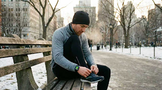 Runner starting a workout on Apple Watch to close activity rings.