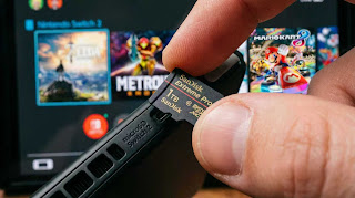 Installing a 1TB high-speed micro SD card into Nintendo Switch 2 to expand storage.