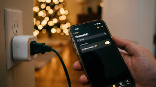 Setting up a smart plug for Christmas tree lights using a smartphone app to control holiday decorations.
