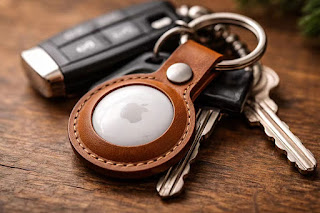 Premium brown leather keychain case for AirTag attached to car keys.