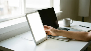 Verilux HappyLight setup on a minimalist desk for work from home productivity.