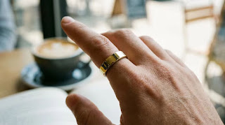 Oura Ring 4 Gold worn on finger featuring all-titanium design.