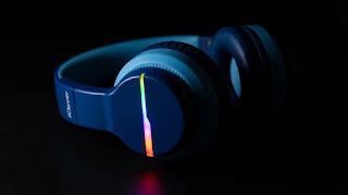 iClever BTH12 kids bluetooth headphones with colorful LED lights glowing in the dark.