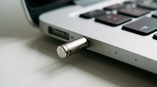 Mic-Lock microphone blocker inserted into a laptop audio jack to prevent audio spying.