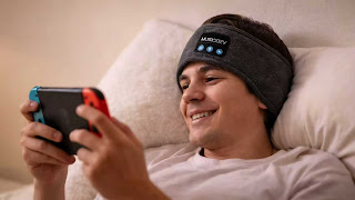 MUSICOZY Bluetooth sleep headphones headband worn by a gamer lying on a pillow.