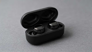 Sony WF-1000XM5 wireless earbuds in charging case.