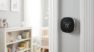 ecobee Smart Thermostat Premium on wall with remote sensor in background, smart zoning system for unevenly heated homes.