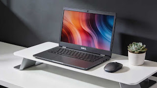 Refurbished Dell XPS 13 laptop setup on a modern white desk.