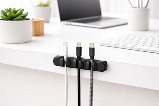 Magnetic cable organizer holding USB-C cables on a minimalist white desk.