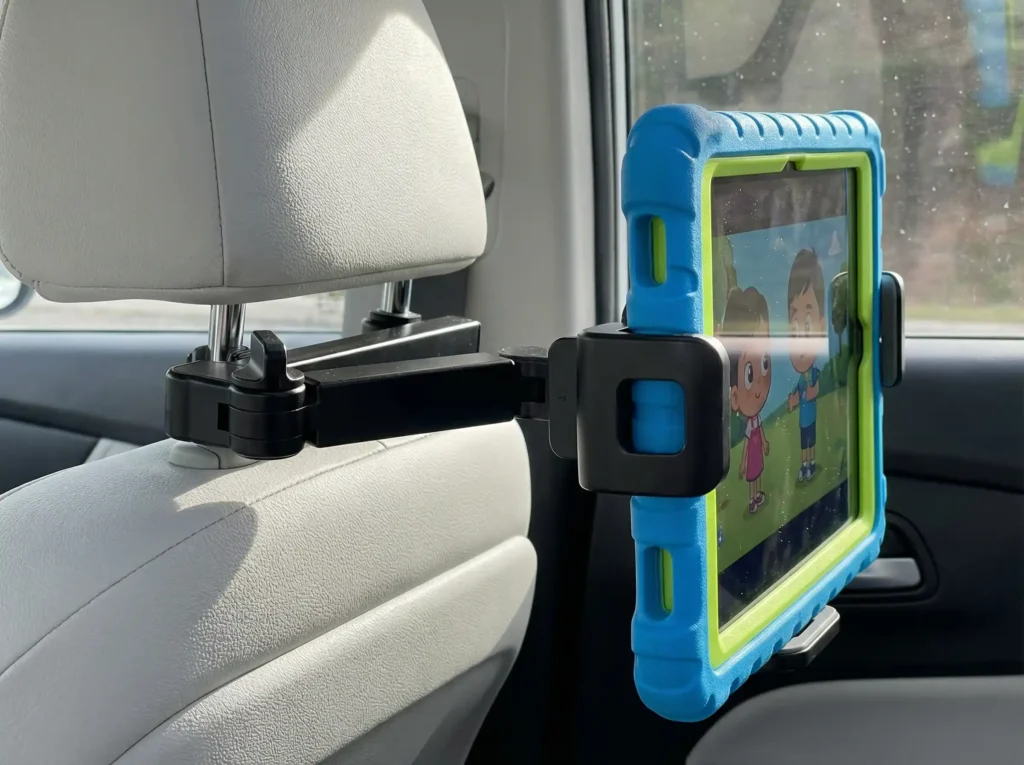 Lamicall car headrest tablet holder gripping an iPad with a thick kid-proof silicone case.