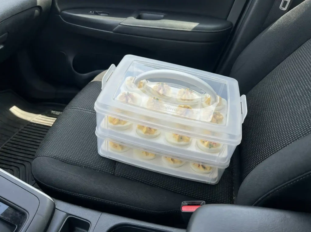 A Snapware 2-layer carrier showing how to transport deviled eggs safely in a car.