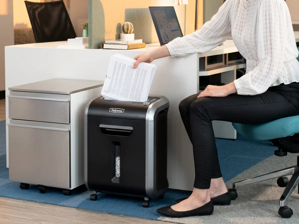 Fellowes Powershred 79Ci 16-sheet cross-cut shredder handling a large stack of stapled tax documents without jamming.