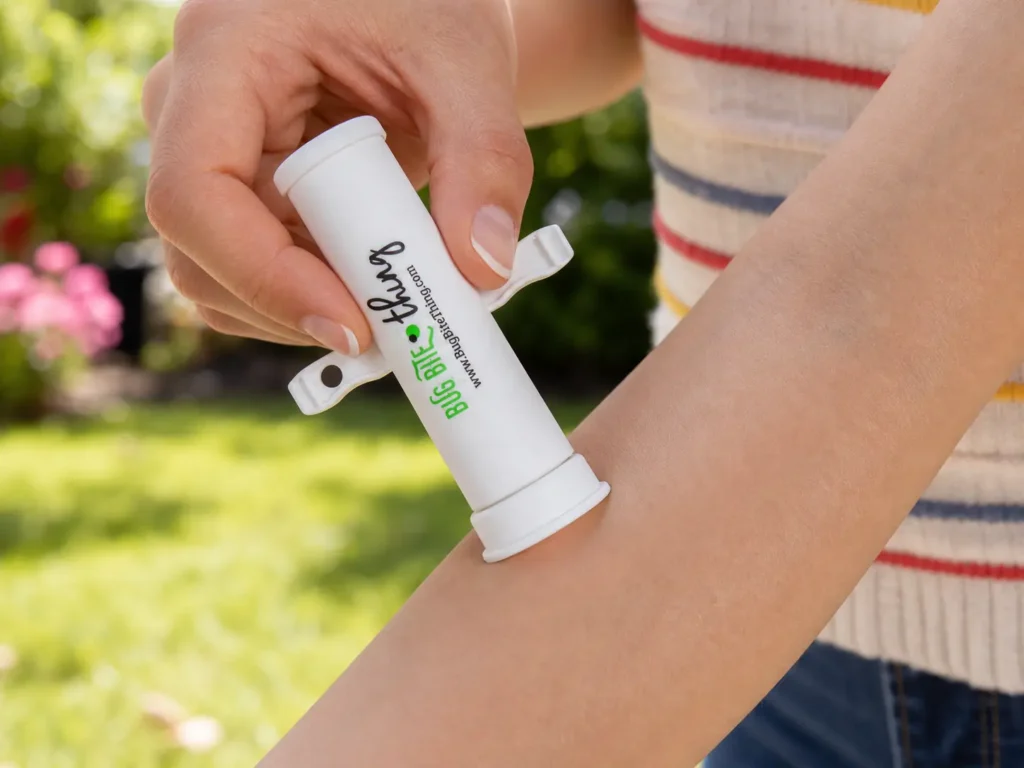 The Bug Bite Thing, widely considered the best suction tool for bug bites, being applied to a forearm outdoors.