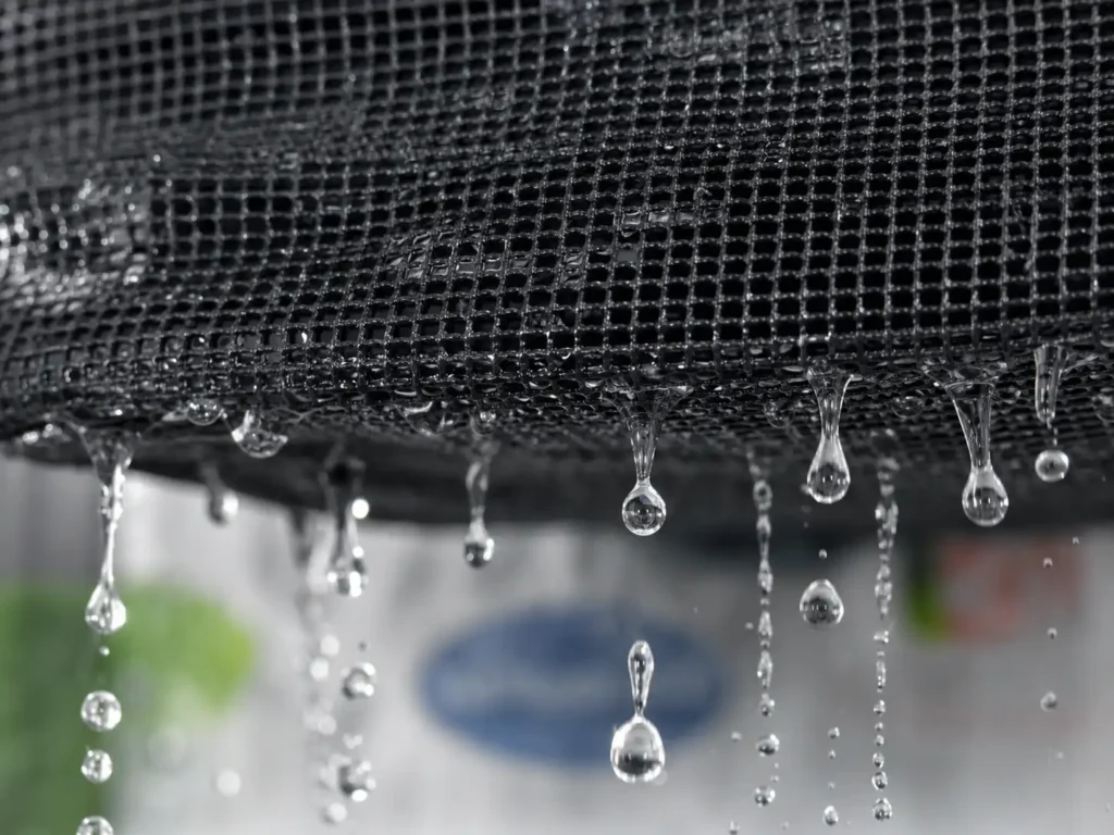 Macro close-up of water draining quickly through the Attmu mesh shower caddy fabric